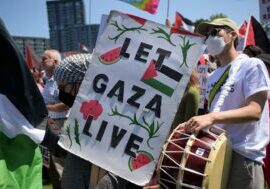 A demonstrator carries a sign ahead of the Democratic National Convention (DNC) near the United Center in Chicago, Illinois, on August 19, 2024.

( Victor J. Blue / Bloomberg via Getty Images)